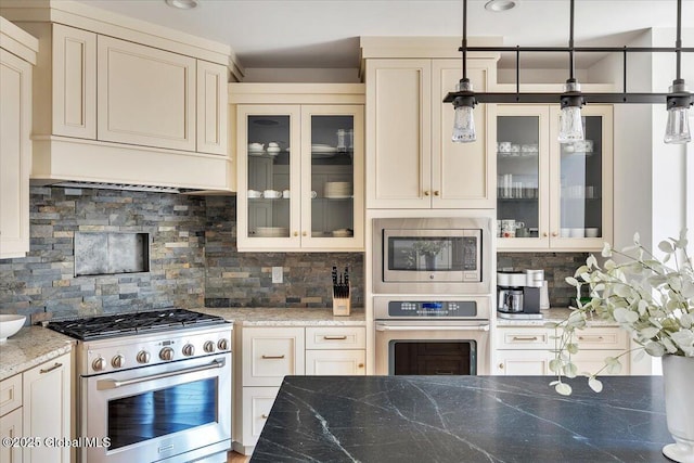 20 Oak Ridge Blvd, Saratoga Springs, NY 12866 - kitchen with light stone counters, tasteful backsplash, stainless steel appliances, and decorative light fixtures