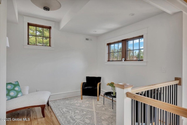 20 Oak Ridge Blvd, Saratoga Springs, NY 12866 - living area with baseboards, visible vents, a healthy amount of sunlight, and wood finished floors