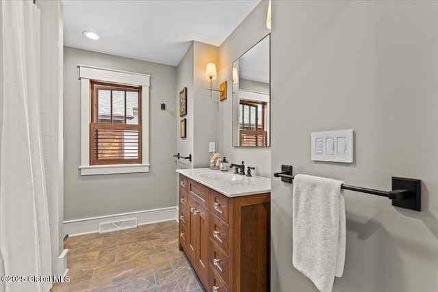 20 Oak Ridge Blvd, Saratoga Springs, NY 12866 - bathroom with visible vents, baseboards, stone finish floor, and vanity