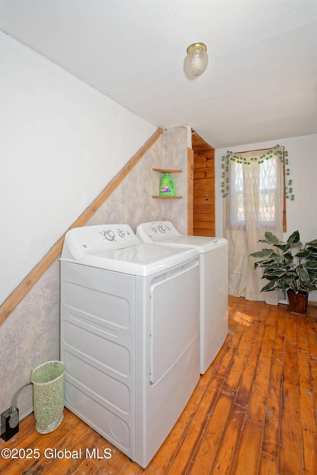 laundry area with laundry area, wood-type flooring, and washing machine and clothes dryer