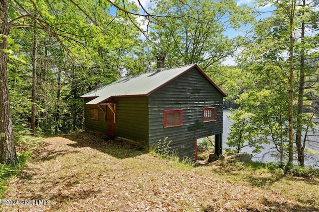 view of property exterior featuring metal roof