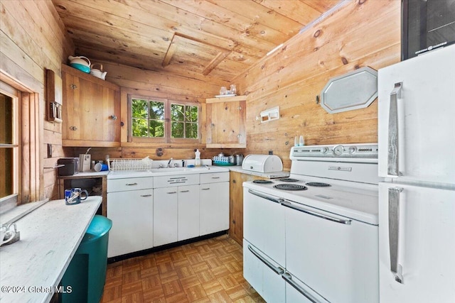 kitchen featuring lofted ceiling, wood walls, light countertops, wooden ceiling, and white appliances