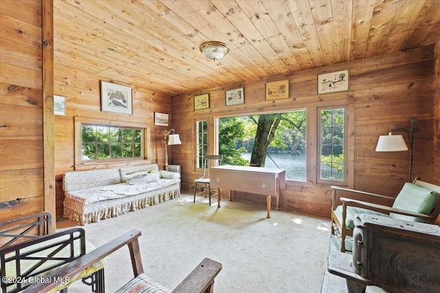 living area with wood ceiling, wood walls, and carpet flooring