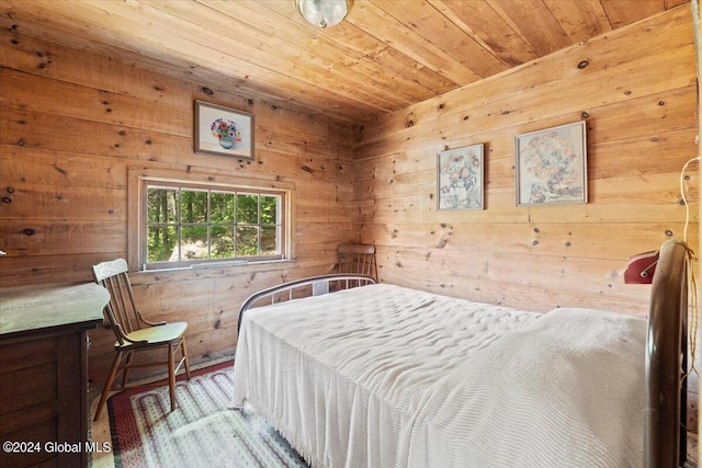 bedroom with wooden ceiling and wood walls