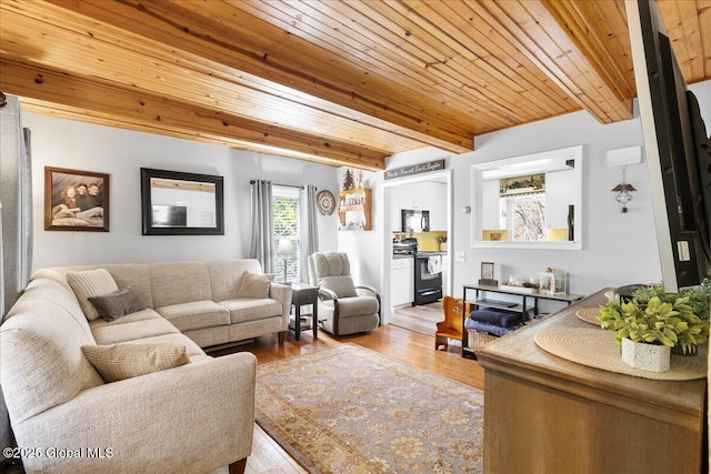 living area with beam ceiling, wood ceiling, and wood finished floors