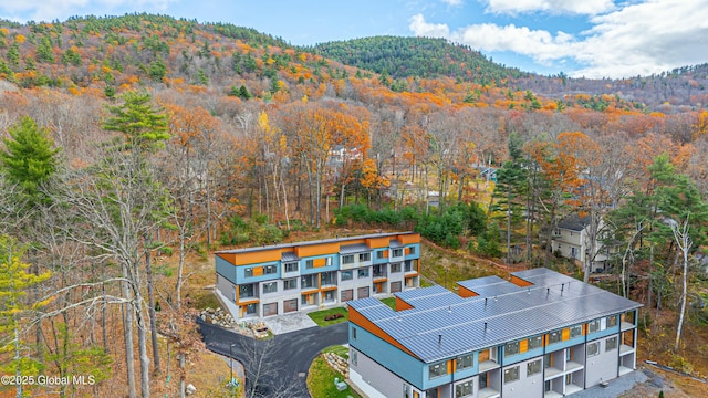 aerial view featuring a forest view and a mountain view