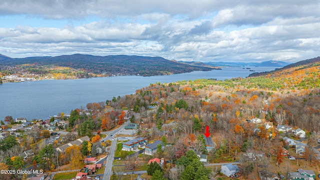 birds eye view of property with a water and mountain view