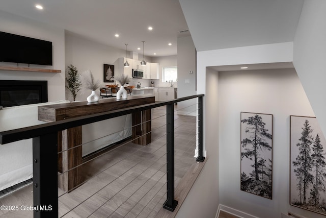 interior space with visible vents, a sink, and a glass covered fireplace