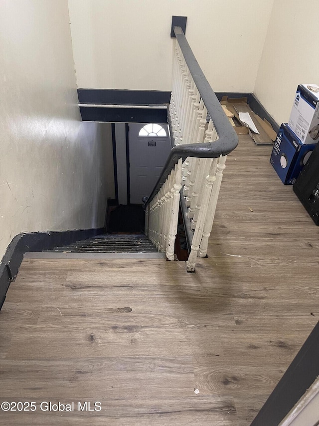 stairway with wood finished floors