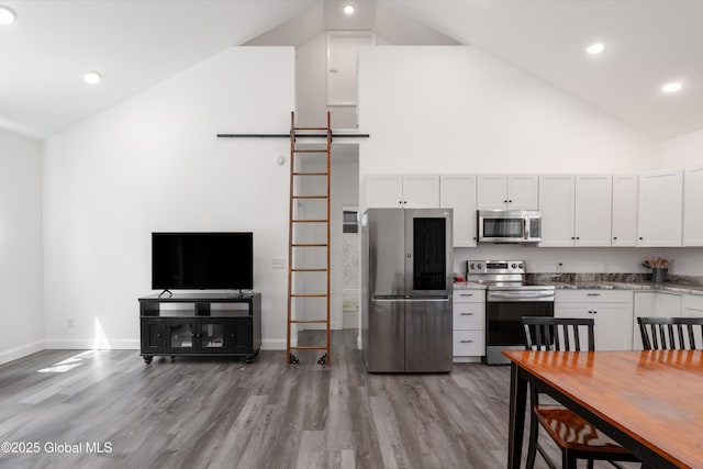 23 Locust Ridge Dr, Corinth, NY 12822 - kitchen with stainless steel appliances, high vaulted ceiling, wood finished floors, baseboards, and recessed lighting