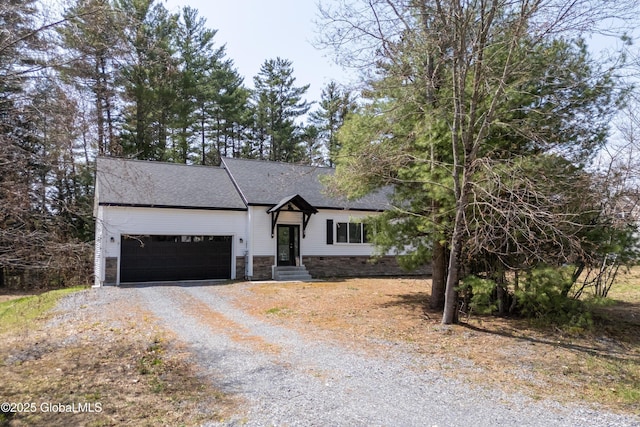 23 Locust Ridge Dr, Corinth, NY 12822 - view of front of house with driveway, a garage, roof with shingles, and stone siding