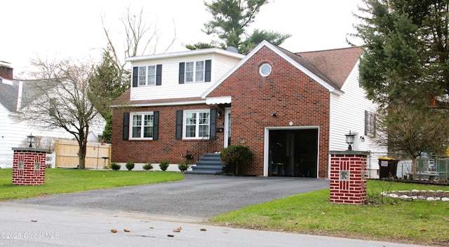 28 Puritan Dr, Rotterdam, NY 12306 - view of front of home with a front yard, a garage, brick siding, fence, and aphalt driveway