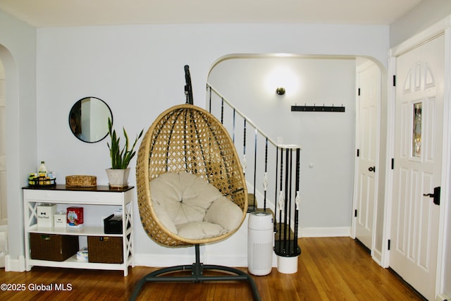 28 Puritan Dr, Rotterdam, NY 12306 - sitting room with stairway, arched walkways, baseboards, and wood finished floors