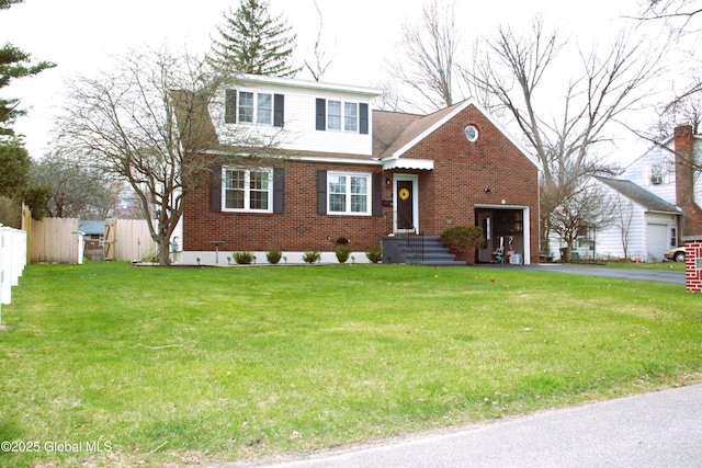 28 Puritan Dr, Rotterdam, NY 12306 - view of front facade featuring brick siding, fence, a front yard, and aphalt driveway