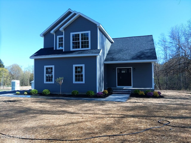 view of front facade featuring roof with shingles