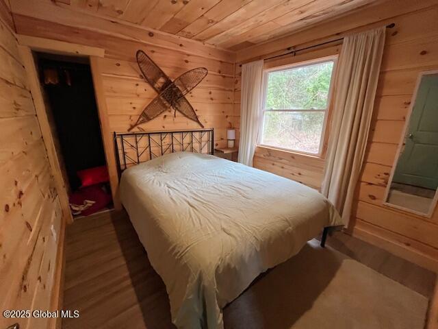15-17 Pine Rd, Lake Luzerne, NY 12846 - bedroom featuring wooden walls, wood ceiling, and wood finished floors