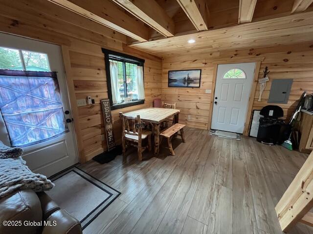 15-17 Pine Rd, Lake Luzerne, NY 12846 - dining space with wood walls, electric panel, and hardwood / wood-style flooring