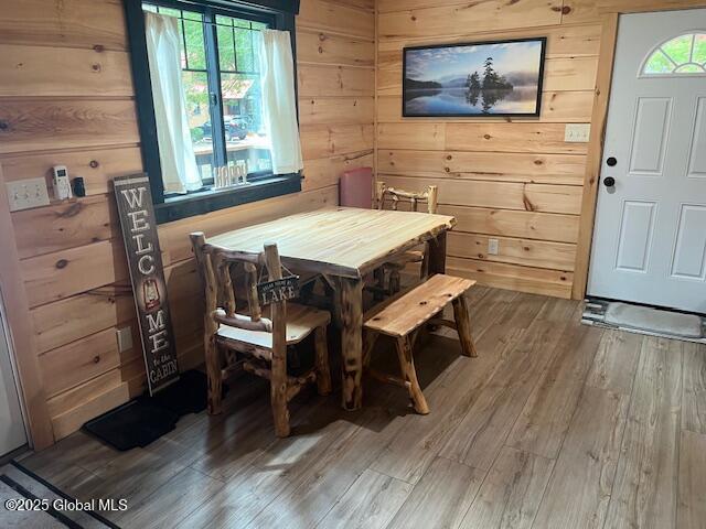 15-17 Pine Rd, Lake Luzerne, NY 12846 - dining space featuring wooden walls and light wood-style flooring