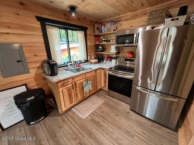 15-17 Pine Rd, Lake Luzerne, NY 12846 - kitchen featuring wood ceiling, a sink, wooden walls, stainless steel appliances, and light wood-style flooring