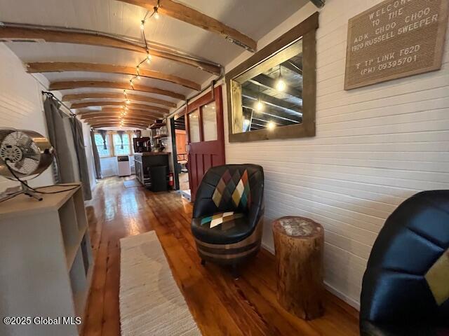 15-17 Pine Rd, Lake Luzerne, NY 12846 - hallway with lofted ceiling with beams, washer / dryer, wooden walls, and hardwood / wood-style flooring