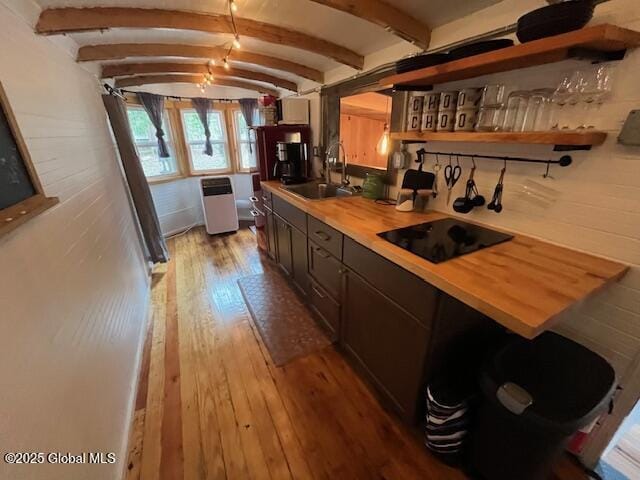 15-17 Pine Rd, Lake Luzerne, NY 12846 - kitchen featuring wooden counters, lofted ceiling with beams, light wood-type flooring, black electric cooktop, and a sink