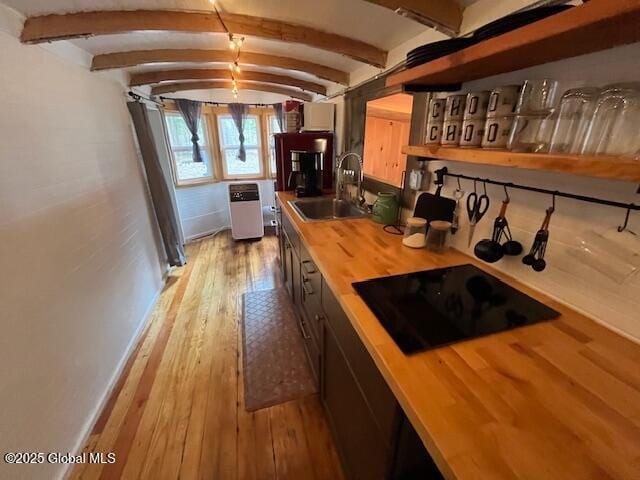 15-17 Pine Rd, Lake Luzerne, NY 12846 - kitchen with a sink, black electric cooktop, butcher block counters, and beam ceiling
