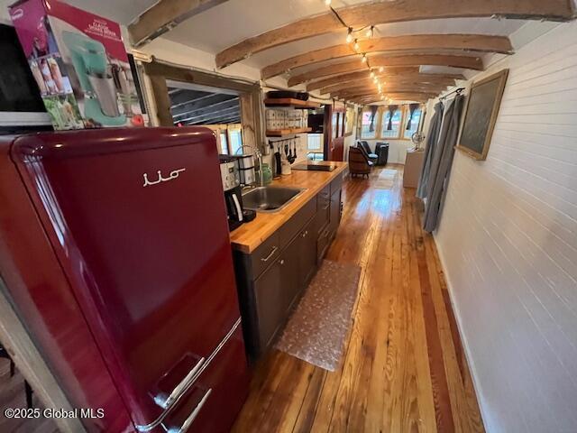 15-17 Pine Rd, Lake Luzerne, NY 12846 - interior space featuring fridge, beam ceiling, a wealth of natural light, and wood finished floors