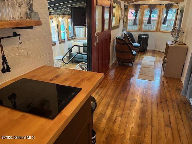 15-17 Pine Rd, Lake Luzerne, NY 12846 - interior space with black electric cooktop, butcher block counters, and hardwood / wood-style flooring