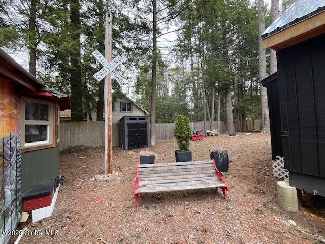15-17 Pine Rd, Lake Luzerne, NY 12846 - view of yard with a storage shed, an outbuilding, and a fenced backyard
