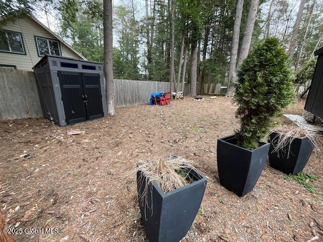 15-17 Pine Rd, Lake Luzerne, NY 12846 - view of yard with an outdoor structure, a shed, and fence