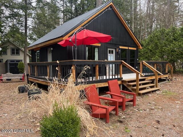 15-17 Pine Rd, Lake Luzerne, NY 12846 - back of property with a wooden deck and metal roof