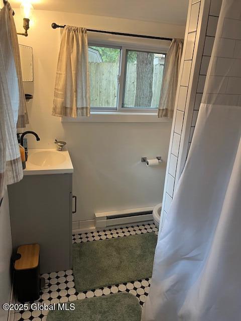 15-17 Pine Rd, Lake Luzerne, NY 12846 - full bath featuring toilet, a baseboard heating unit, and vanity