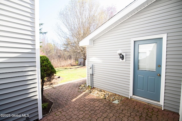 view of exterior entry featuring a patio area