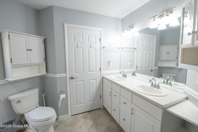 bathroom with toilet and a sink