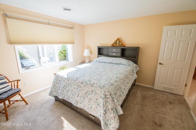 bedroom featuring baseboards, carpet flooring, and visible vents