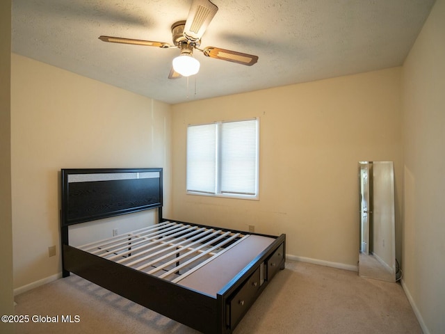 carpeted bedroom featuring baseboards and ceiling fan