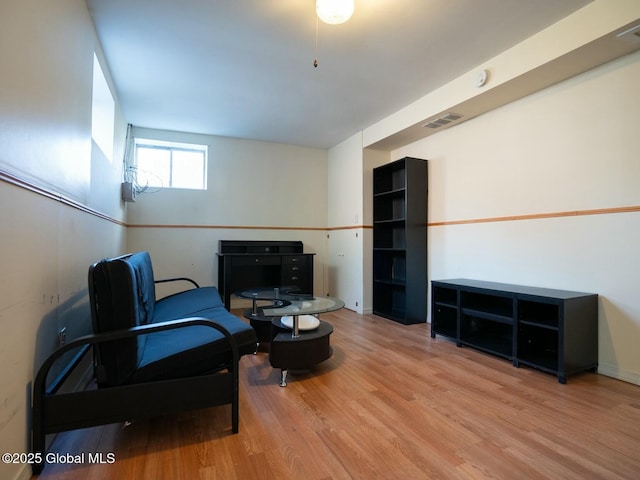 sitting room with visible vents and wood finished floors