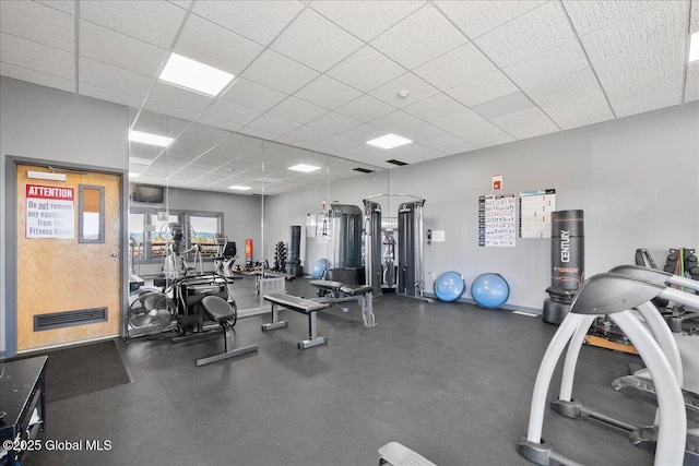 exercise room with a drop ceiling