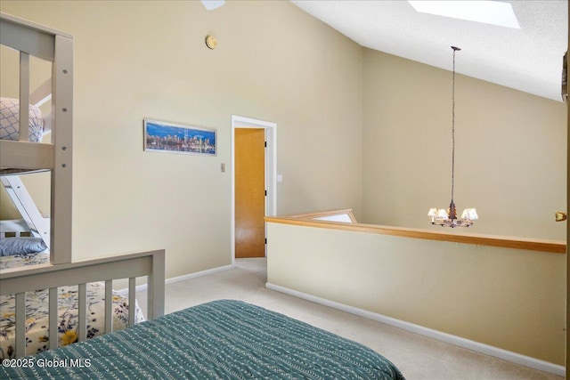 bedroom featuring baseboards, high vaulted ceiling, a chandelier, carpet flooring, and a skylight