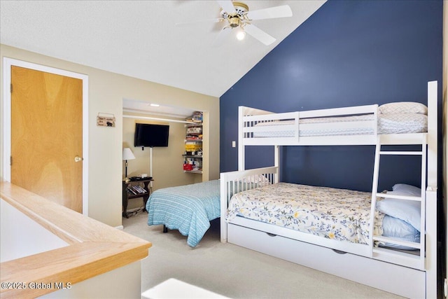 carpeted bedroom with a ceiling fan and high vaulted ceiling