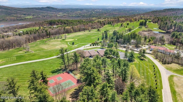 aerial view with view of golf course and a wooded view