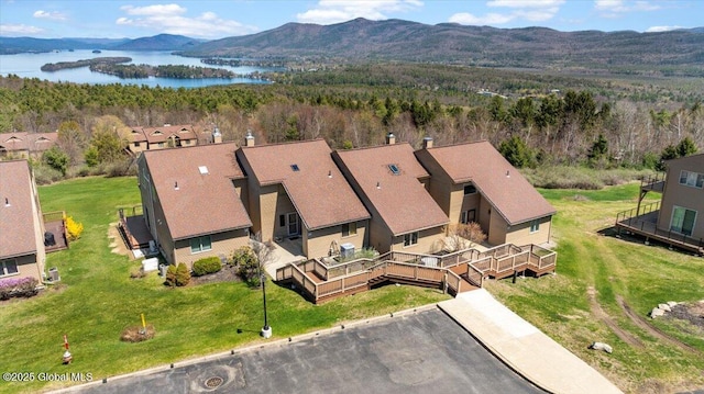 aerial view featuring a water and mountain view, a residential view, and a forest view