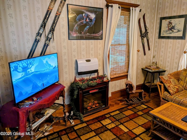 sitting room featuring wallpapered walls and baseboards