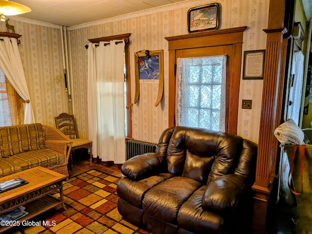 living room featuring wallpapered walls and ornamental molding