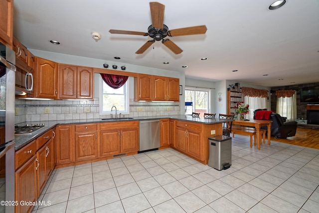 37 Old Hickory Rd, Brunswick, NY 12180 - kitchen with a peninsula, a sink, stainless steel appliances, brown cabinetry, and open floor plan