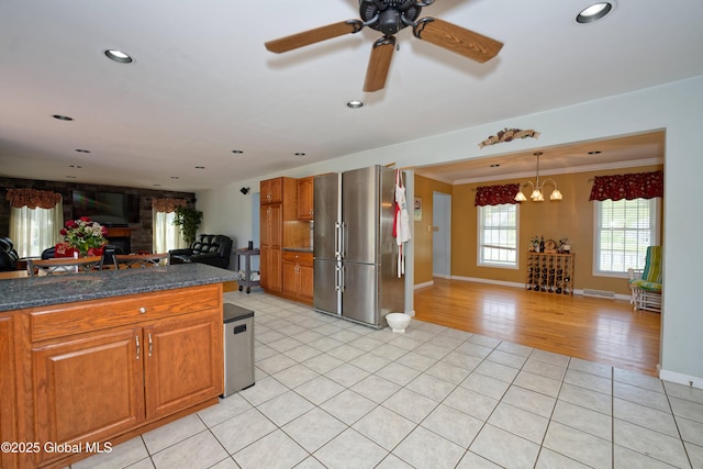 37 Old Hickory Rd, Brunswick, NY 12180 - kitchen with brown cabinets, freestanding refrigerator, light tile patterned flooring, open floor plan, and baseboards