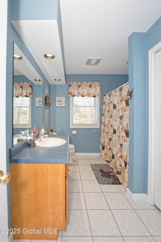 37 Old Hickory Rd, Brunswick, NY 12180 - bathroom with tile patterned flooring, toilet, baseboards, and a healthy amount of sunlight