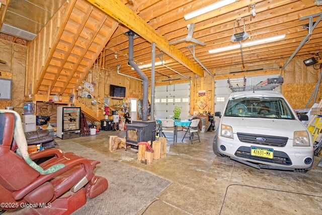 37 Old Hickory Rd, Brunswick, NY 12180 - garage with a wood stove and a garage door opener