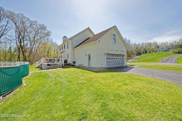 37 Old Hickory Rd, Brunswick, NY 12180 - view of side of property with an attached garage, a chimney, a lawn, a deck, and driveway
