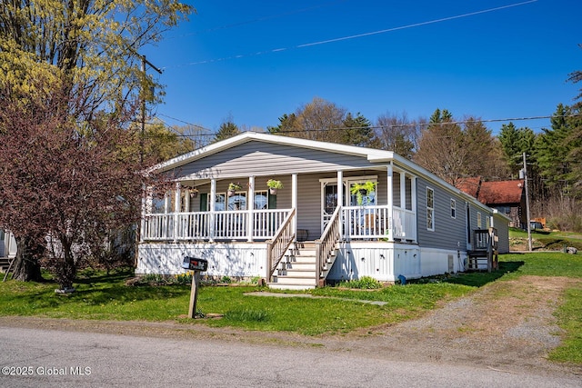 view of front of property featuring covered porch and a front yard